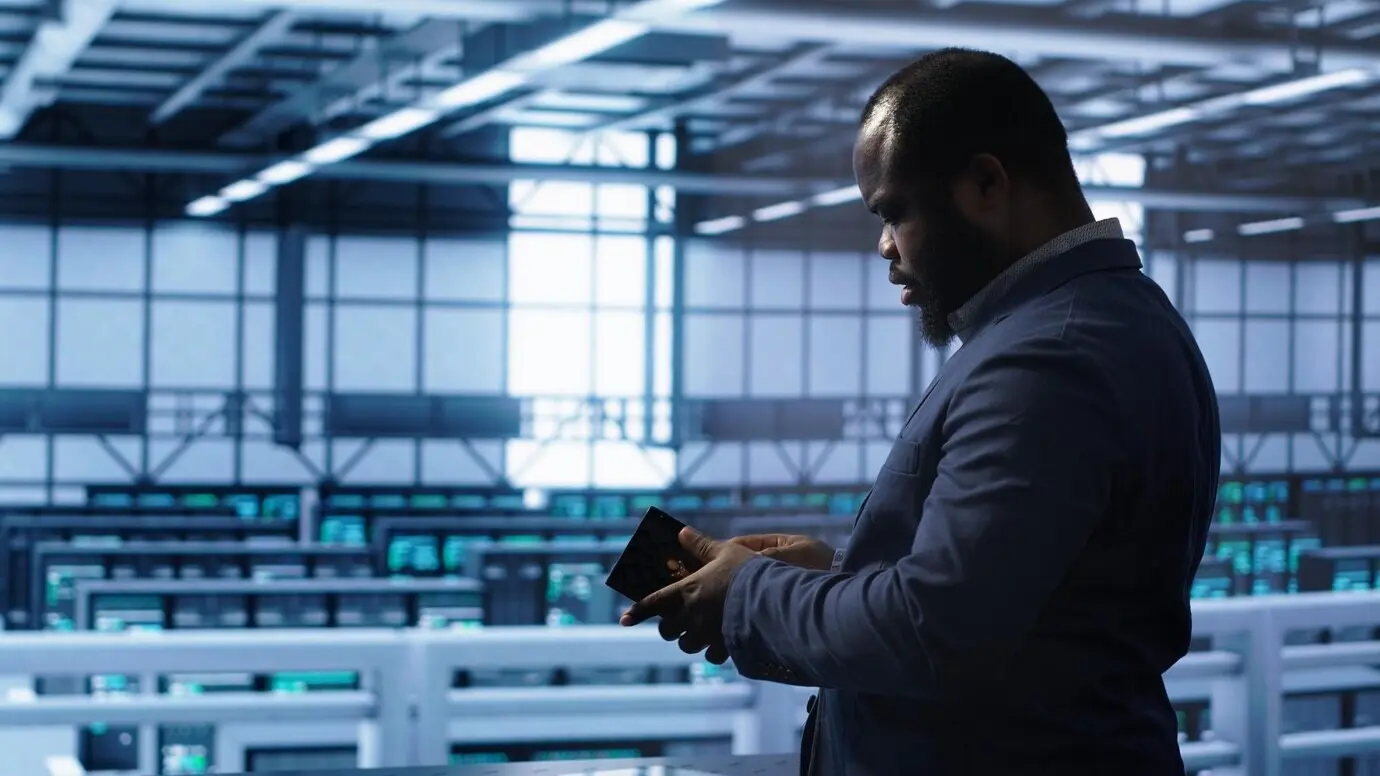 A system administrator in a server room installing a newly ordered storage unit